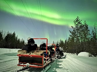 Northern lights sledge ride by snowmobile